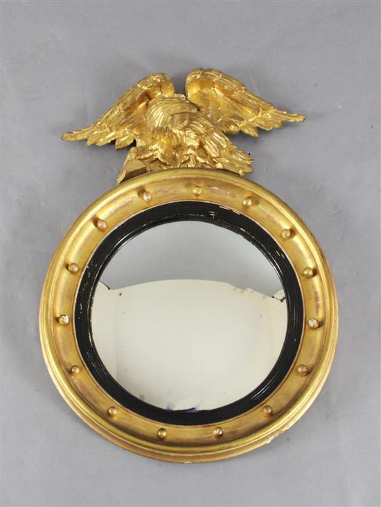 A Regency giltwood and ebonised circular convex mirror, Diam. 2ft